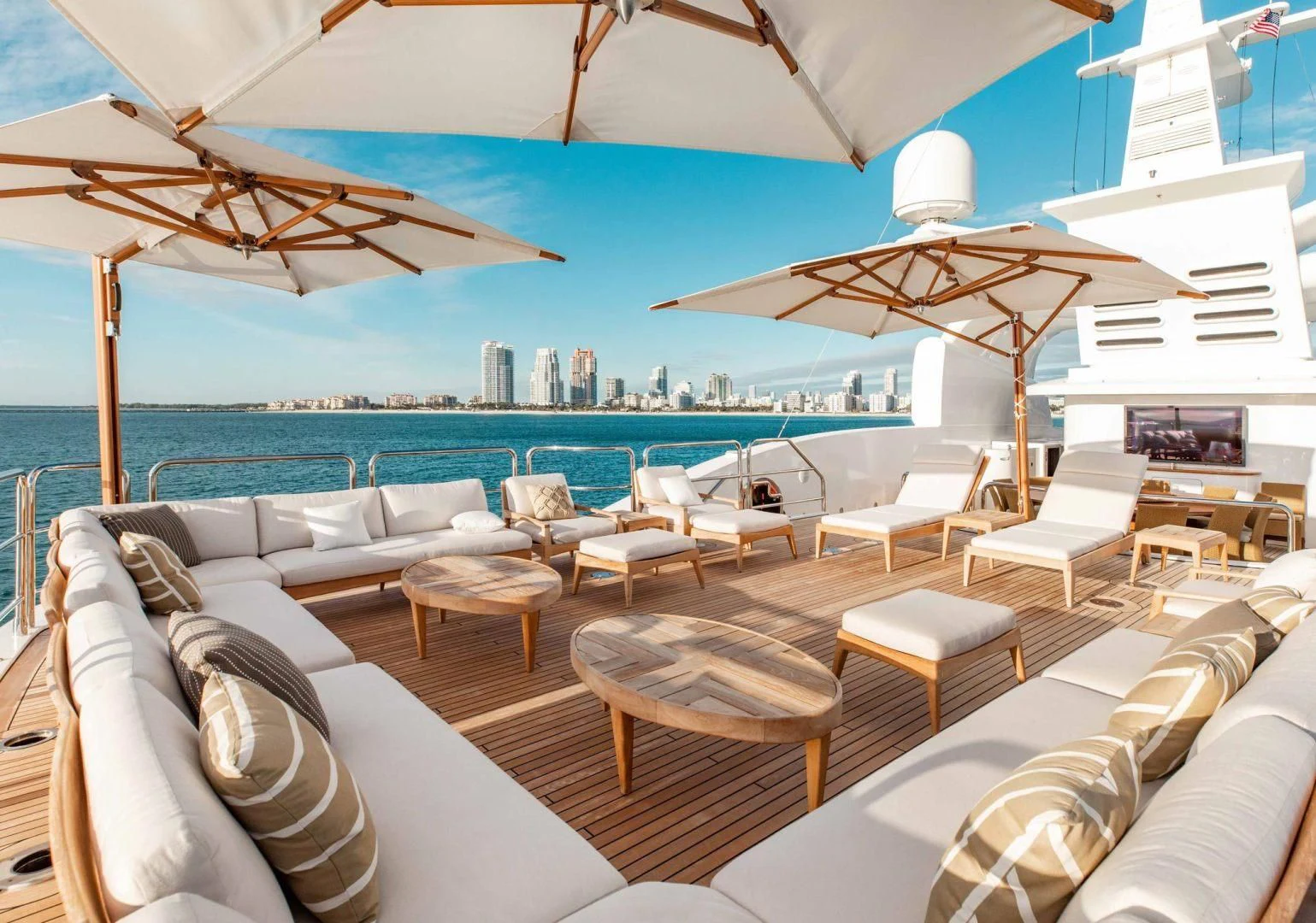 a lounge area with a lounge chair and umbrellas aboard SORRENTO Yacht for Sale