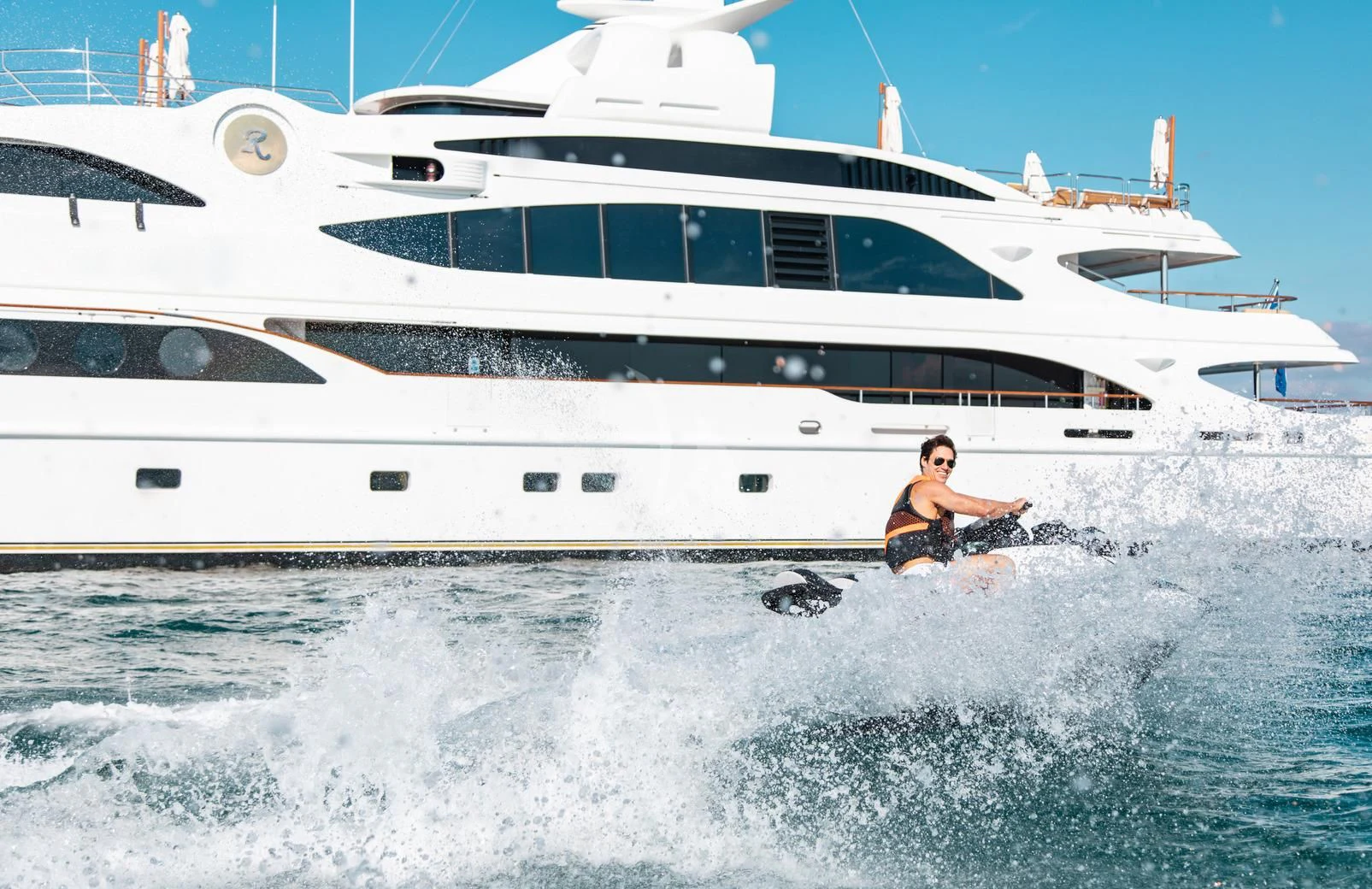 a man in the water next to a boat aboard SORRENTO Yacht for Sale