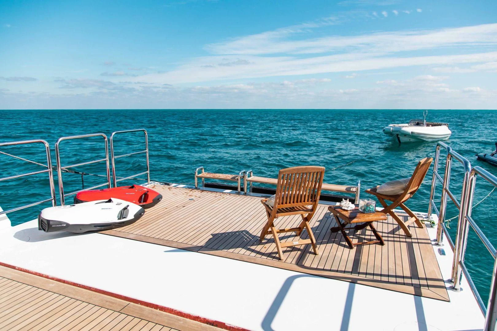 a deck with chairs and a boat on it aboard SORRENTO Yacht for Sale