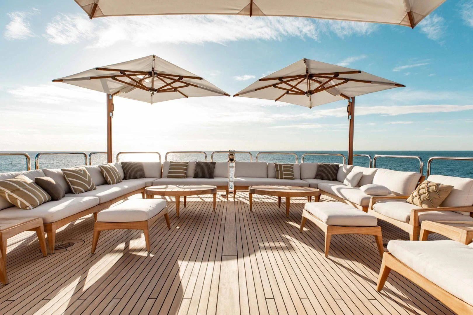 a large lounge area with chairs and umbrellas aboard SORRENTO Yacht for Sale