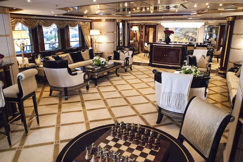 a living room with a table chairs and a television aboard SORRENTO Yacht for Sale