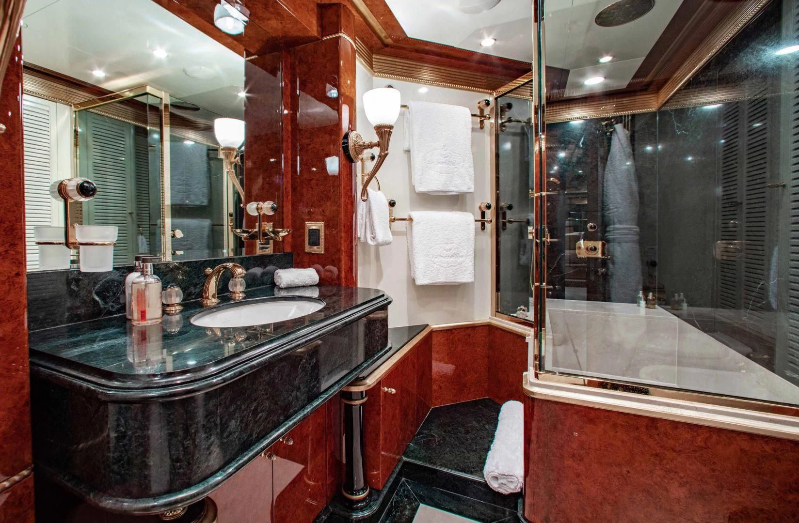 a bathroom with a countertop sink and a large mirror aboard SORRENTO Yacht for Sale