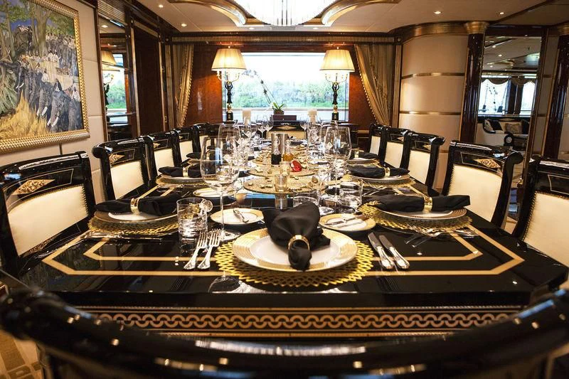 a table set with plates and glasses aboard SORRENTO Yacht for Sale