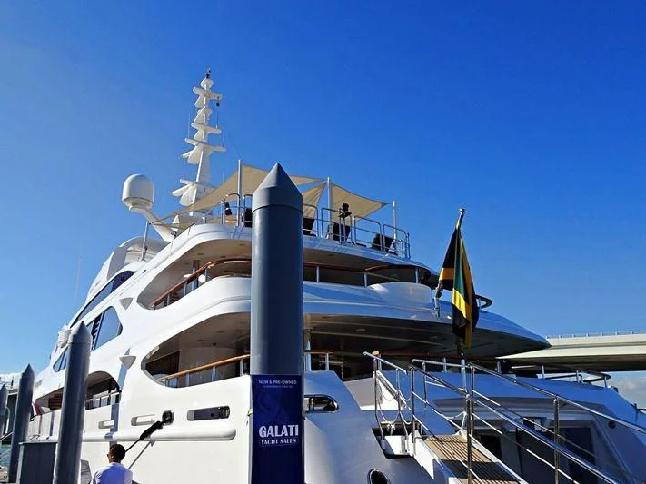 a large white boat with a blue pole and a tower on top aboard SORRENTO Yacht for Sale