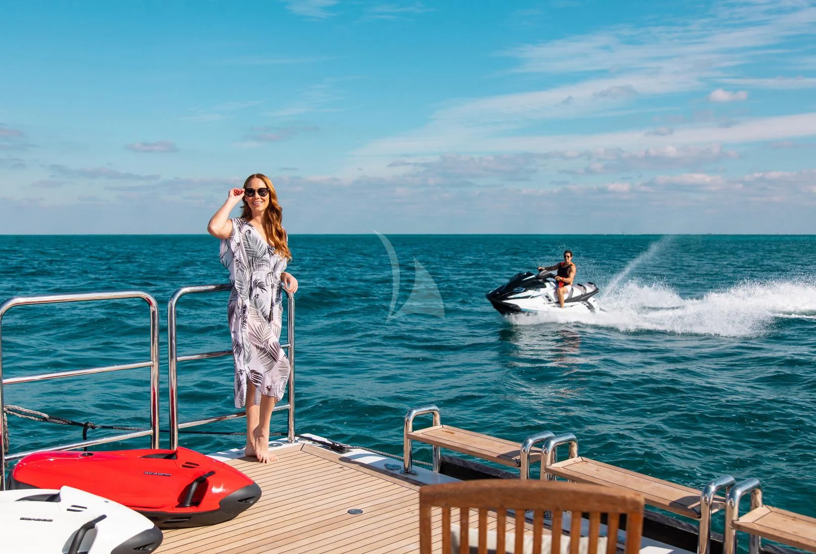 a woman standing on a boat and looking at a man on a boat aboard SORRENTO Yacht for Sale
