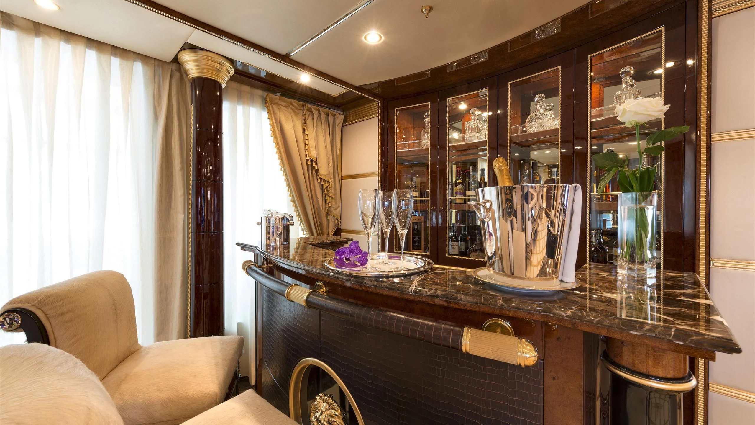 a dining table with a vase of flowers on it aboard SORRENTO Yacht for Sale