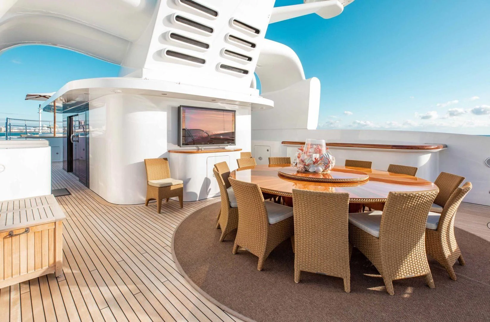 a large room with a table and chairs and a tv aboard SORRENTO Yacht for Sale