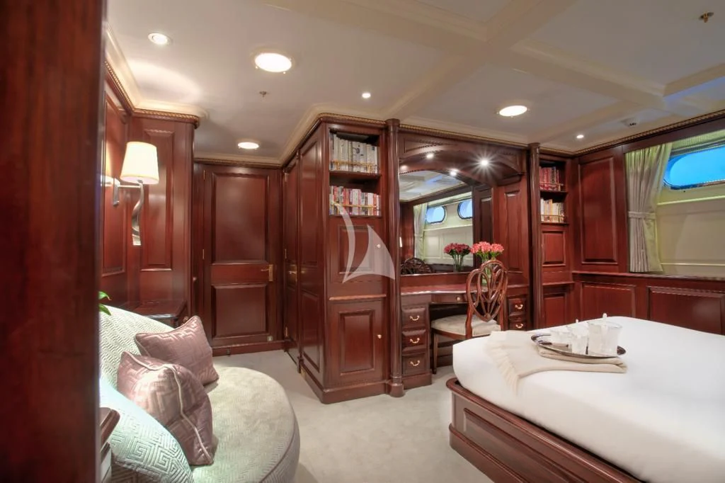 a bedroom with a bed and a table aboard TELEOST Yacht for Sale