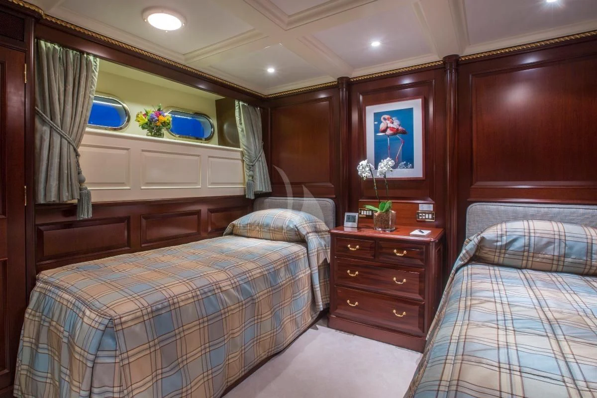 a bedroom with a couple of beds aboard TELEOST Yacht for Sale
