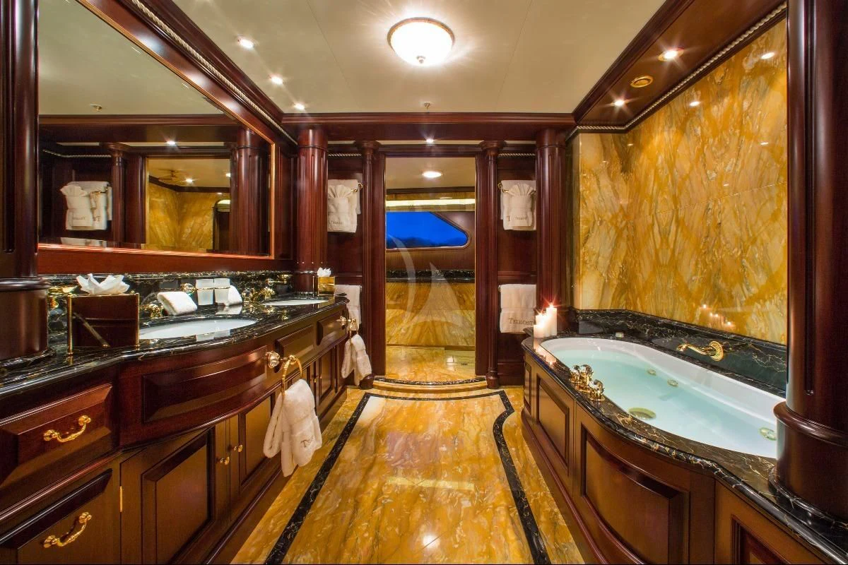 a bathroom with a tub and sinks aboard TELEOST Yacht for Sale