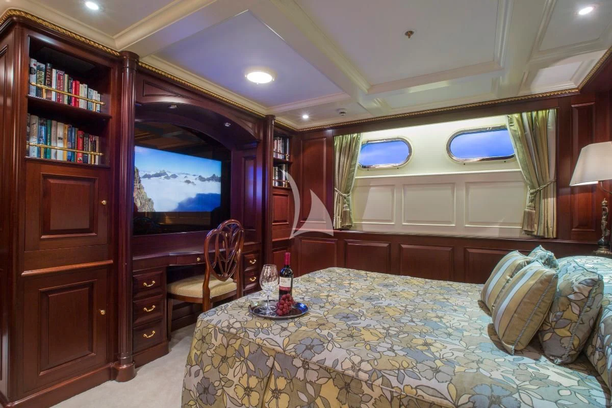 a bedroom with a bed and a tv aboard TELEOST Yacht for Sale
