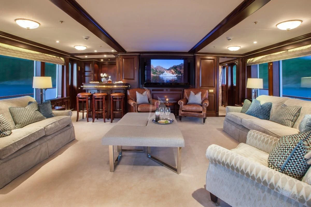 a living room with a large television aboard TELEOST Yacht for Sale
