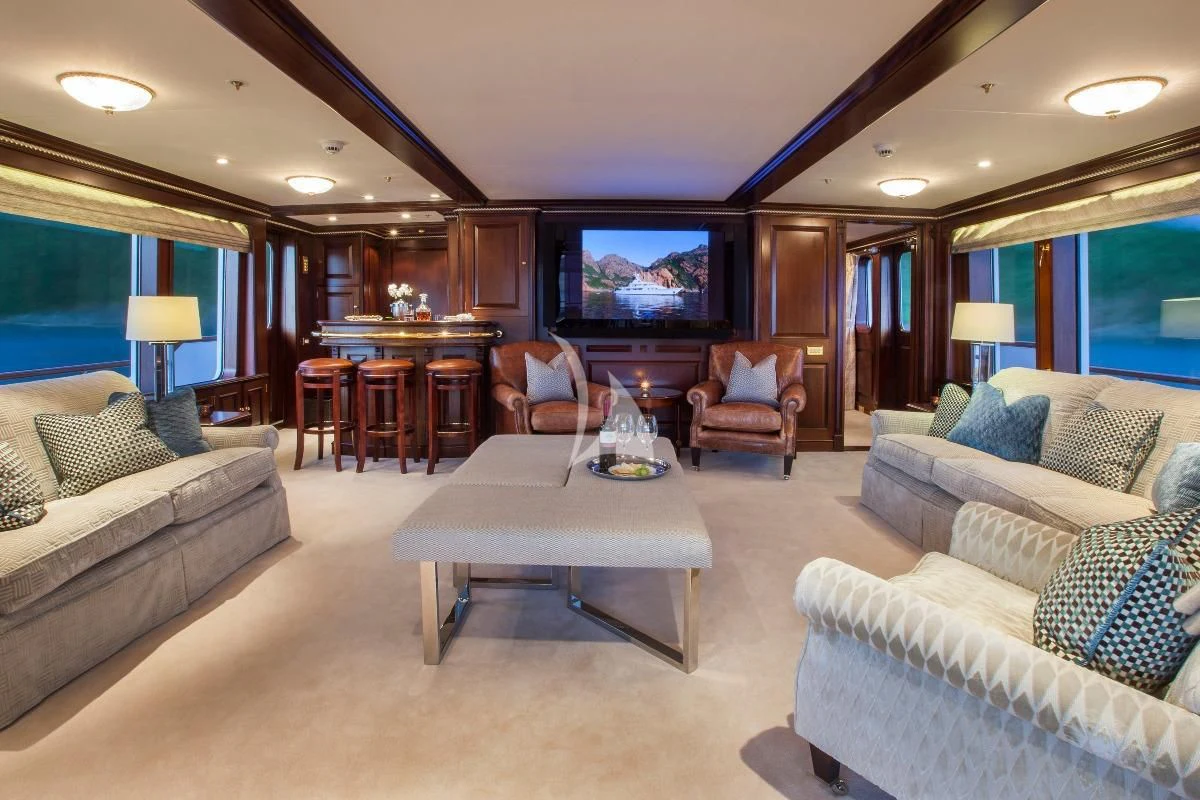 a living room with a large television aboard TELEOST Yacht for Sale