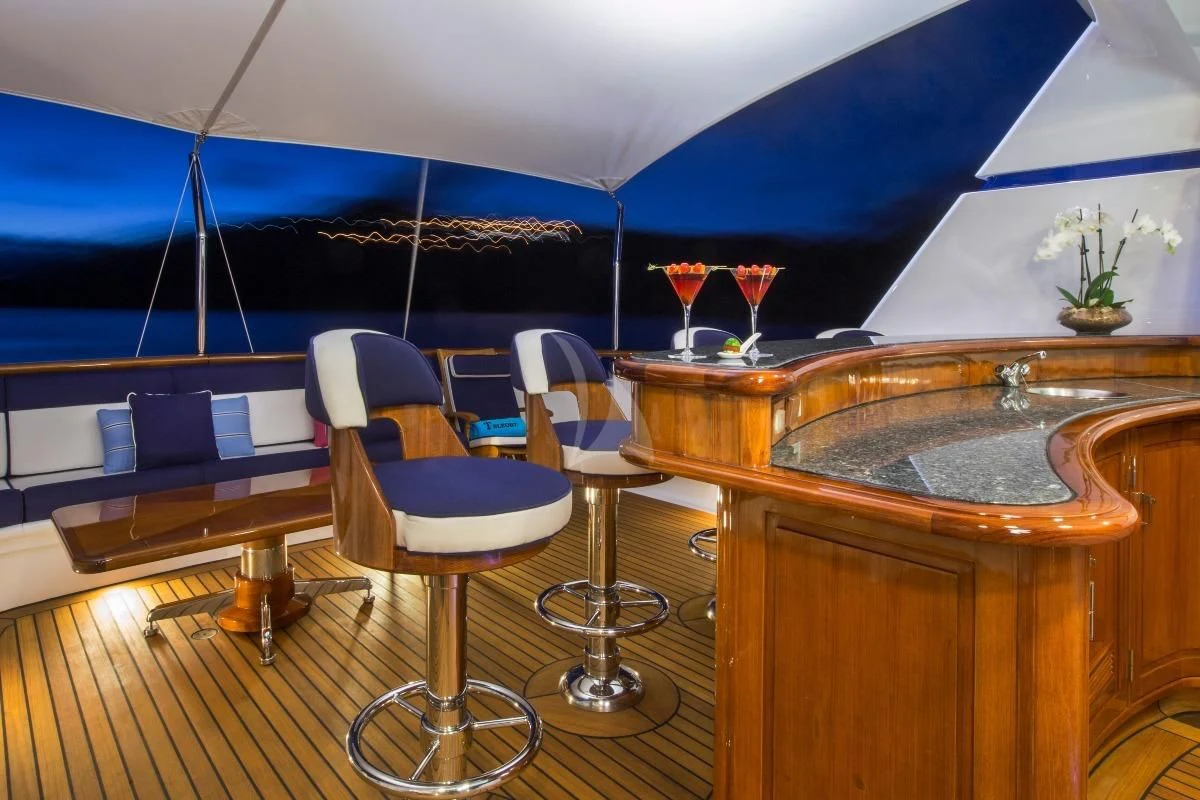 a table with wine glasses on it aboard TELEOST Yacht for Sale