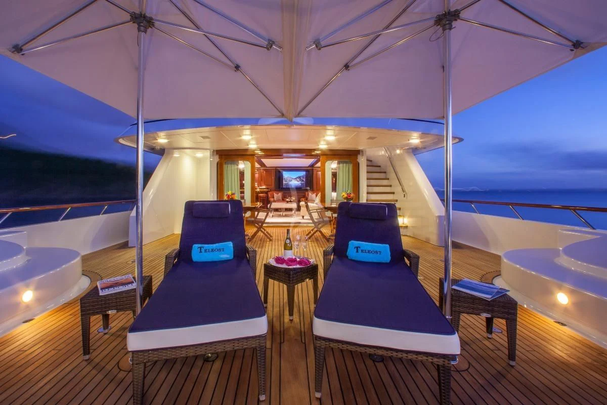 a tent with a bed and a table and chairs aboard TELEOST Yacht for Sale