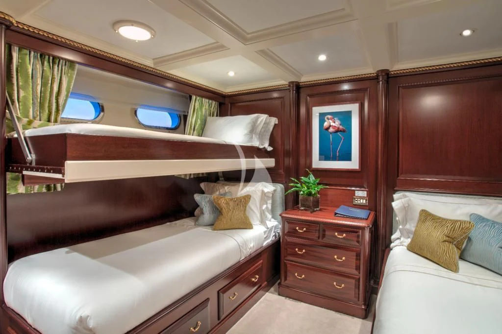 a room with a bed and a dresser aboard TELEOST Yacht for Sale