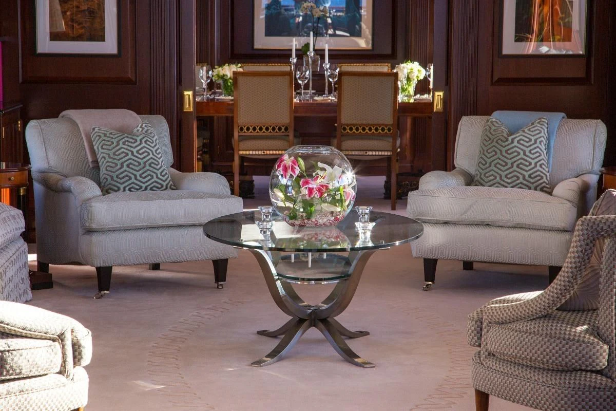 a living room with a table and chairs aboard TELEOST Yacht for Sale