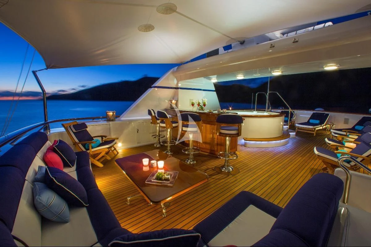 a large lounge area with a large pool and a large deck aboard TELEOST Yacht for Sale