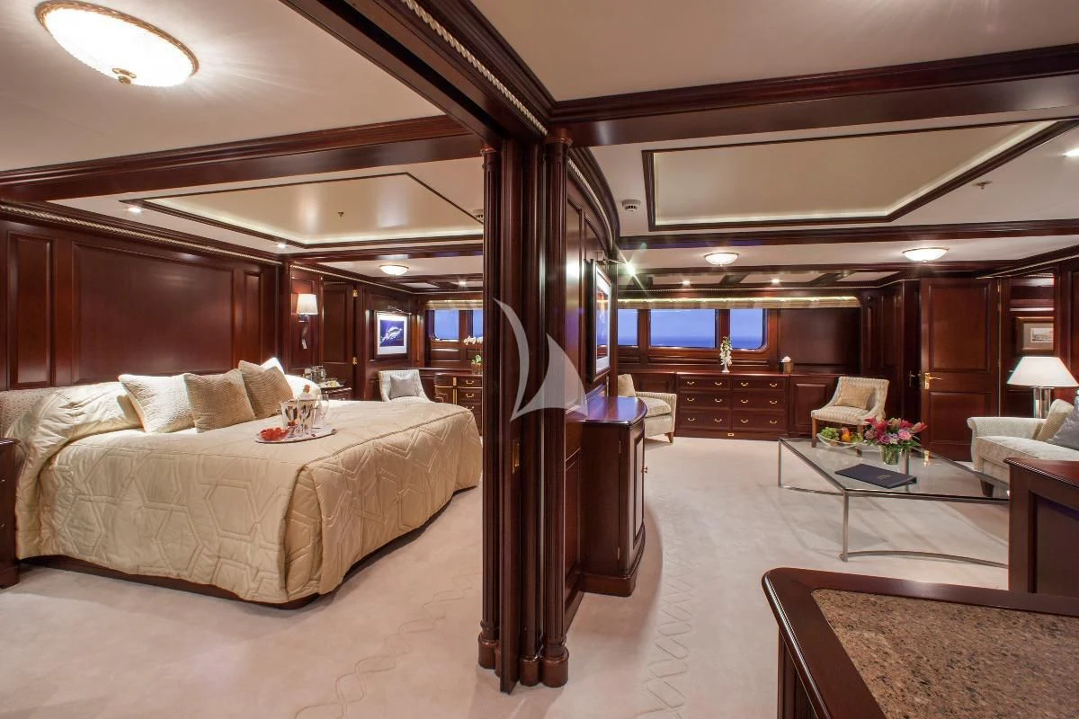 a bedroom with a bed and a table aboard TELEOST Yacht for Sale
