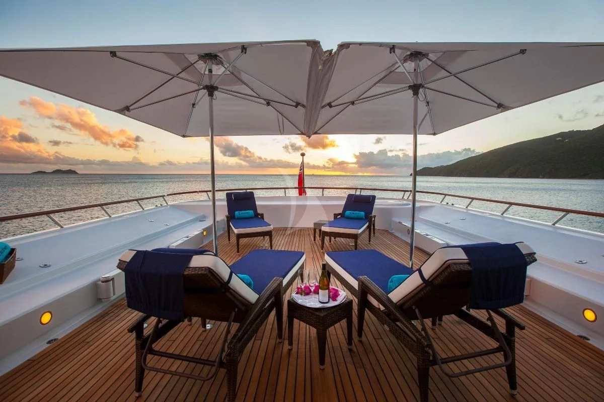a deck with chairs and tables on it aboard TELEOST Yacht for Sale