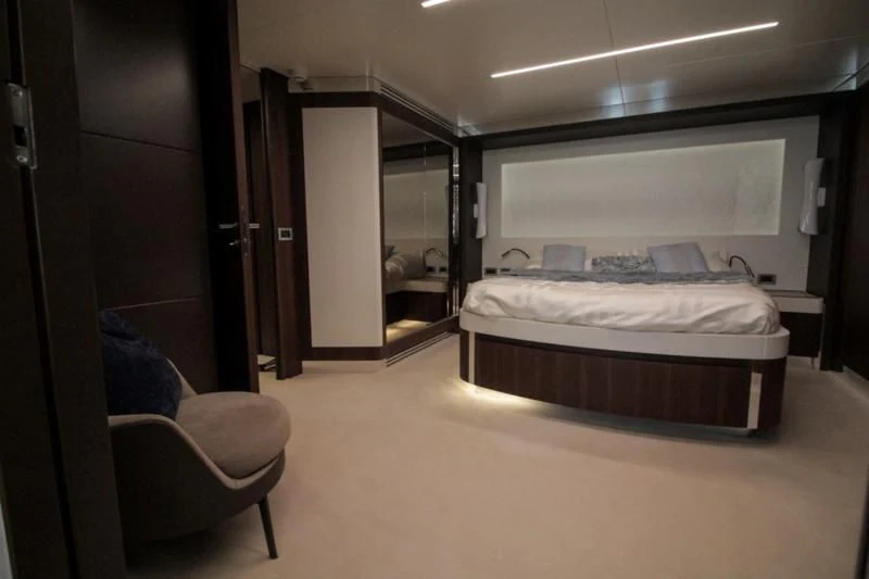 a room with a bed and a chair aboard SEDA Yacht for Sale