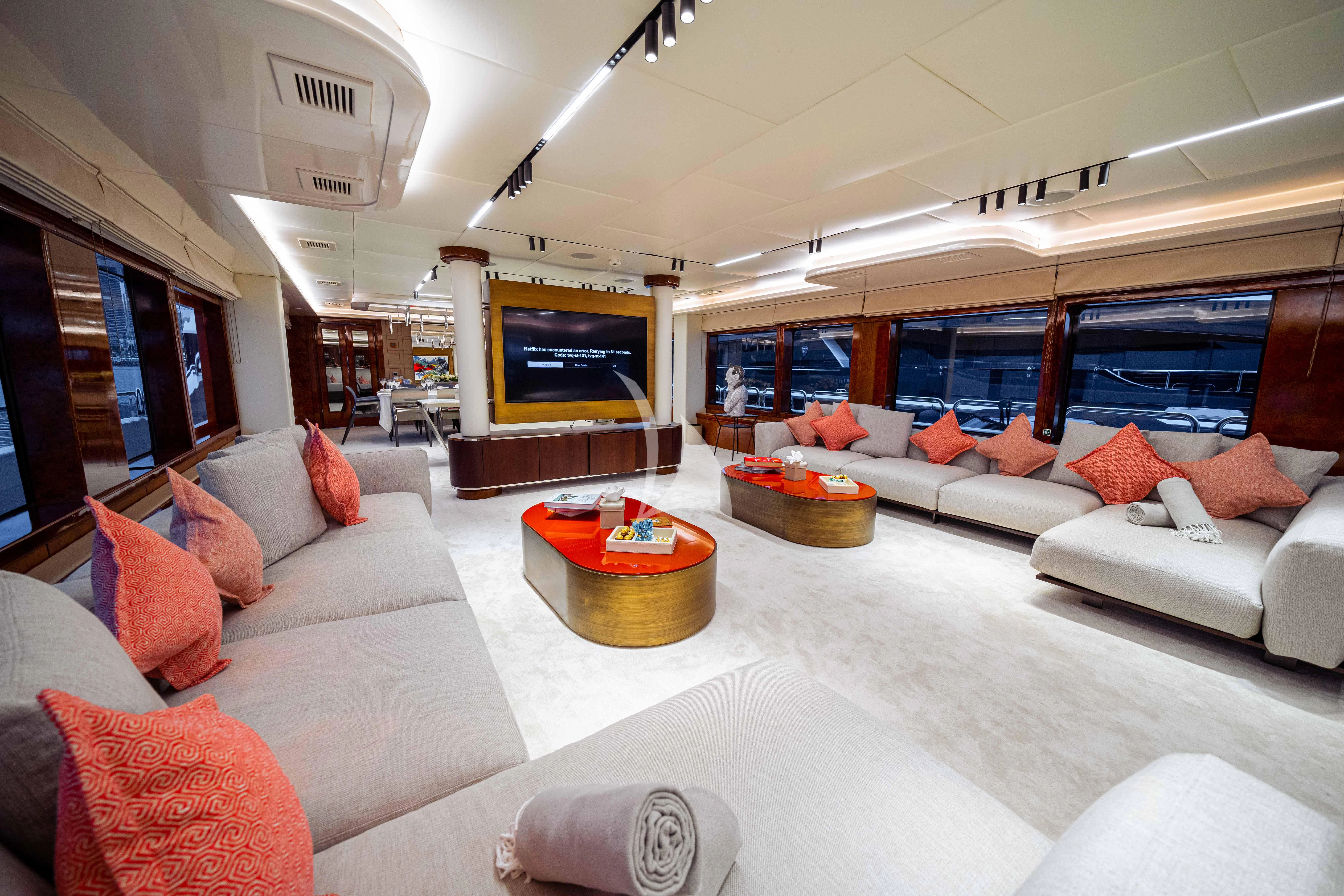a living room with a large sofa aboard HALLO Yacht for Sale