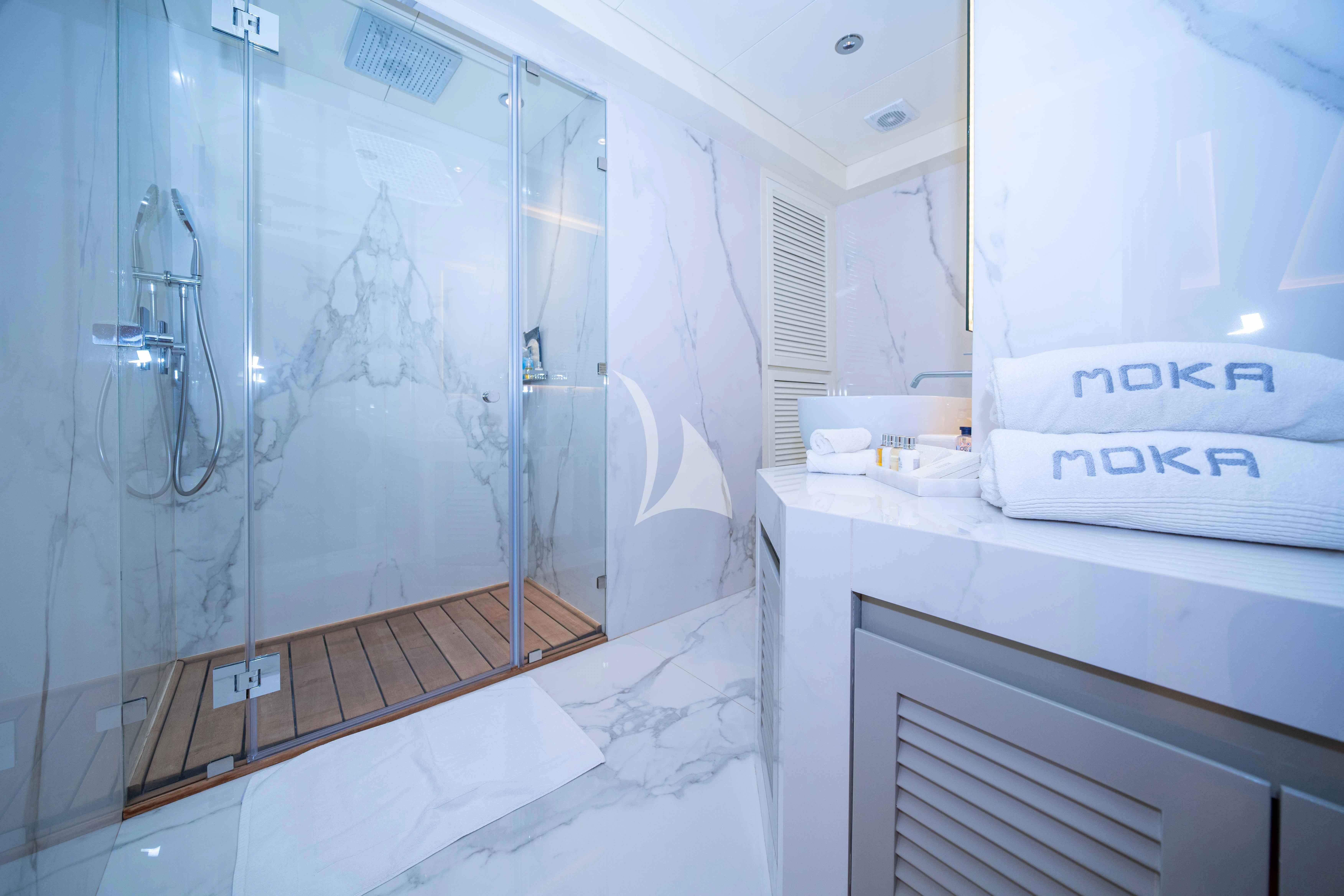 a bathroom with a glass shower aboard HALLO Yacht for Sale