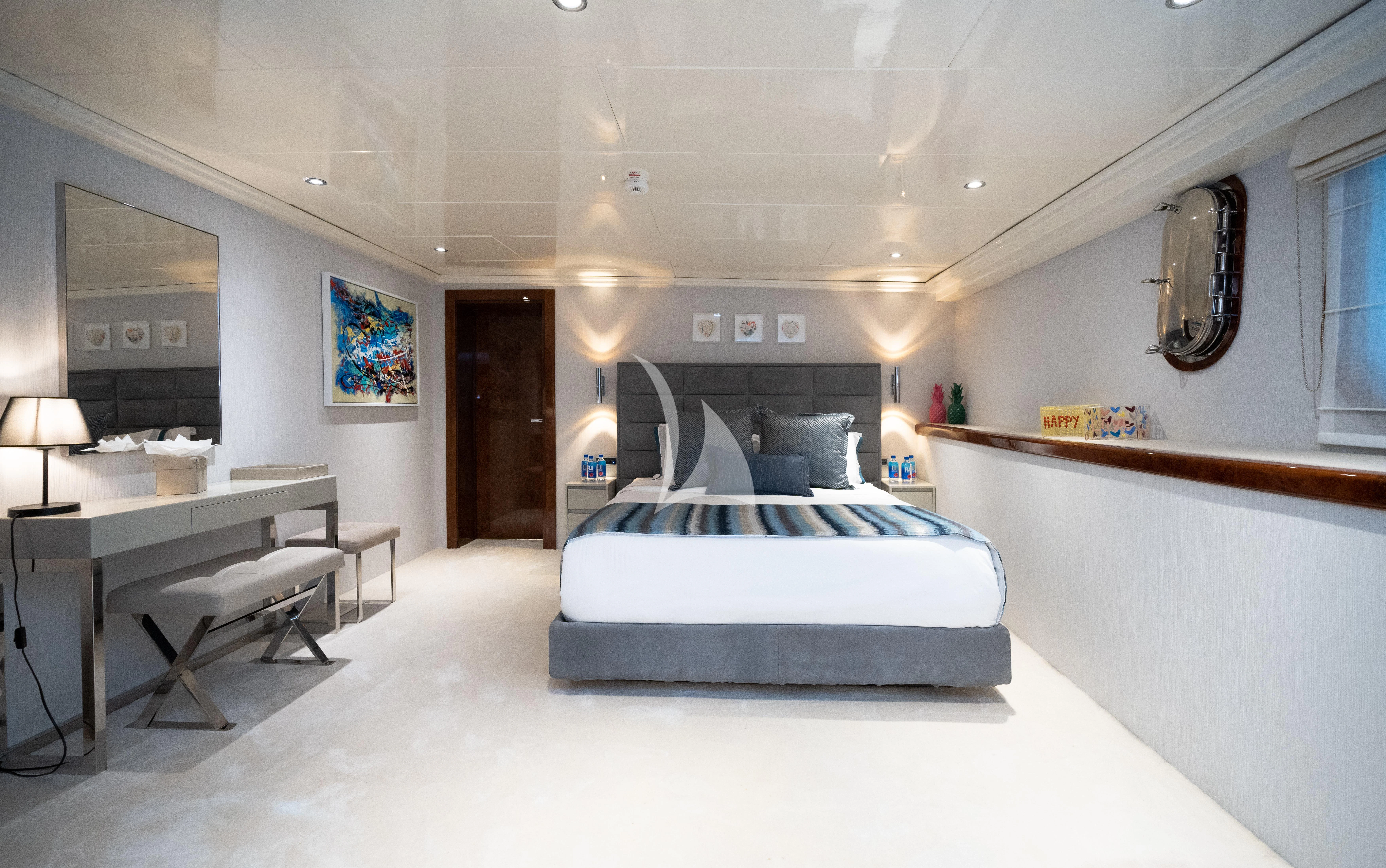 a hospital room with a bed and desk aboard HALLO Yacht for Sale