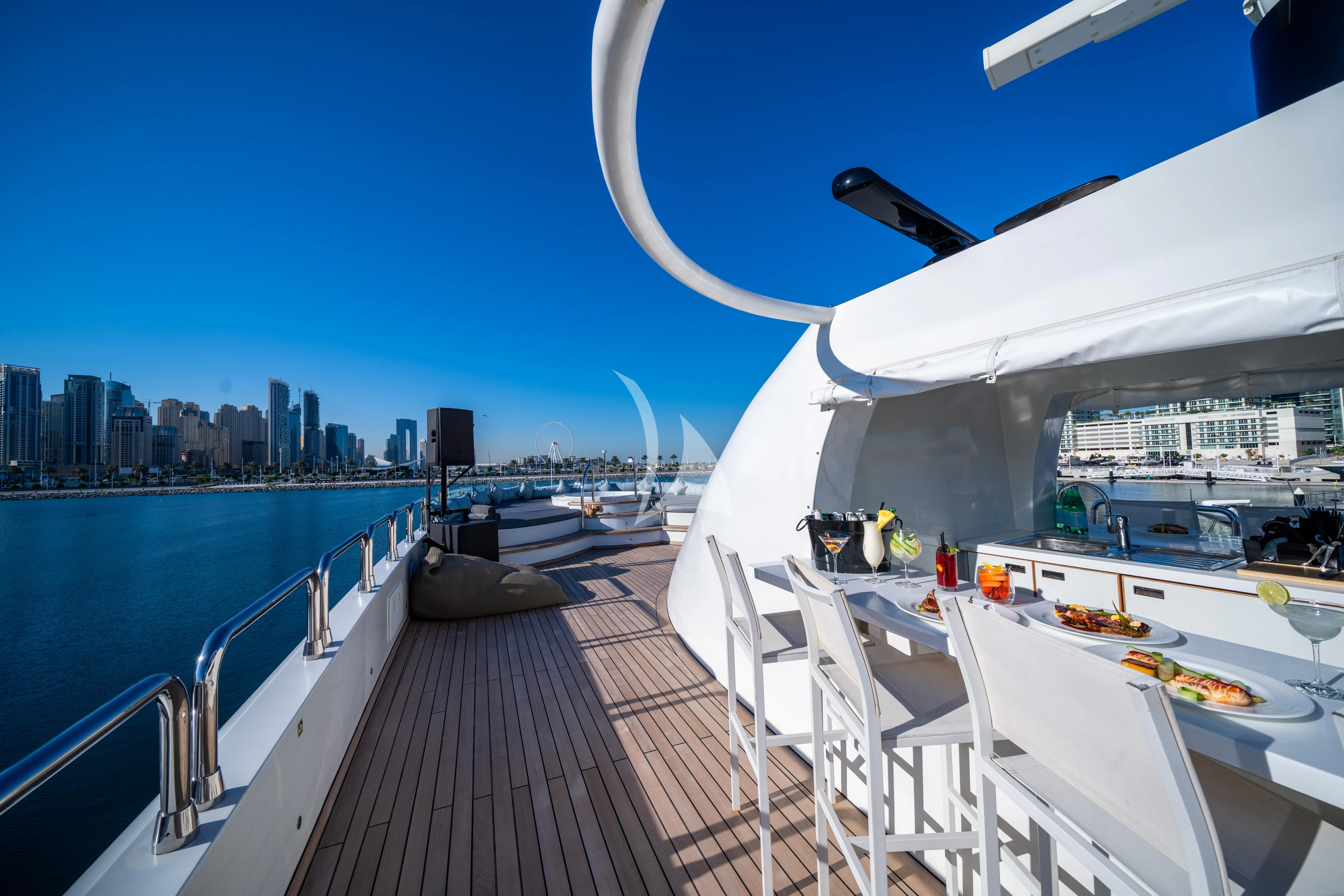 a deck with a view of a city and water aboard HALLO Yacht for Sale