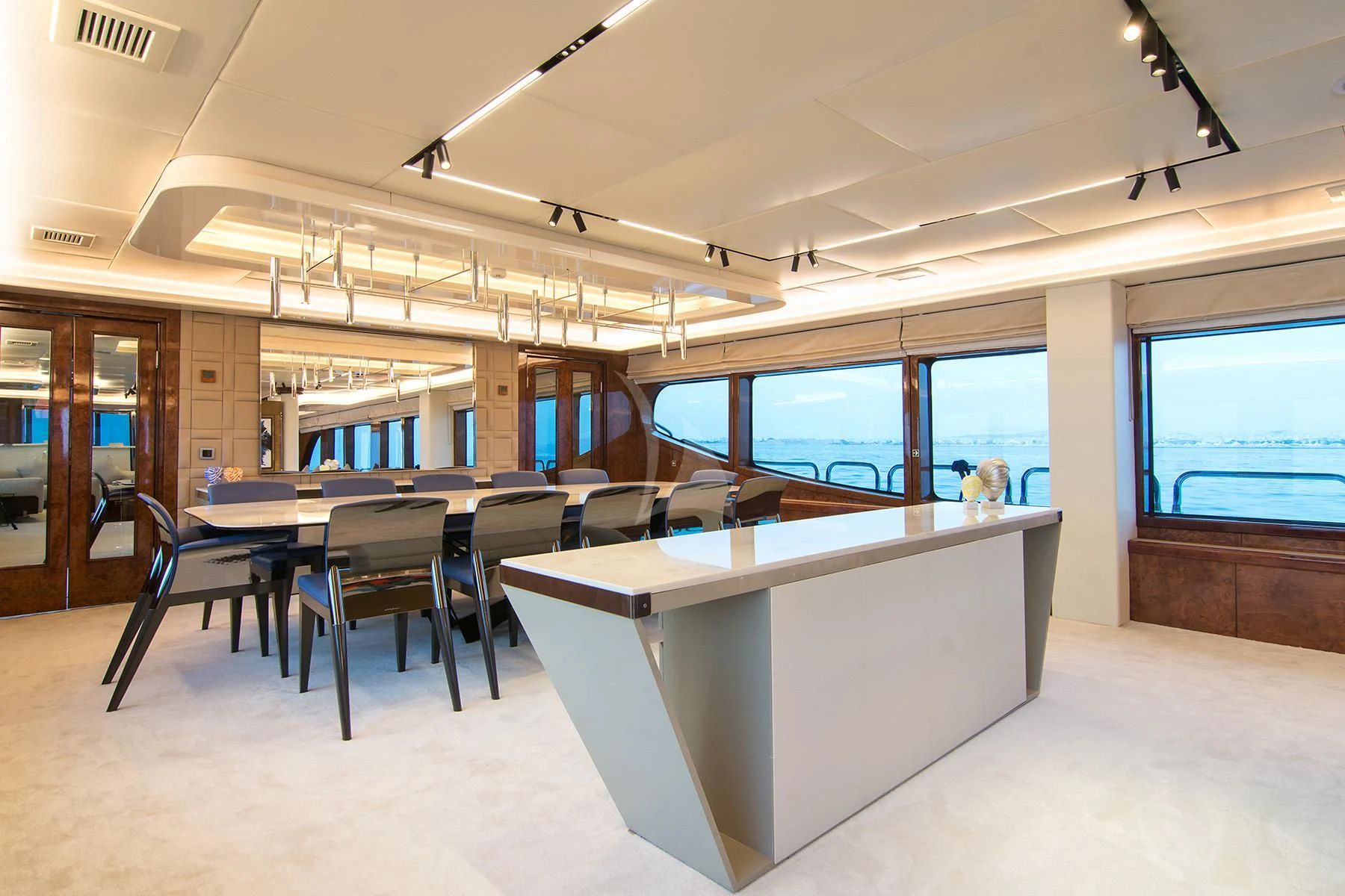 a room with tables and chairs aboard HALLO Yacht for Sale