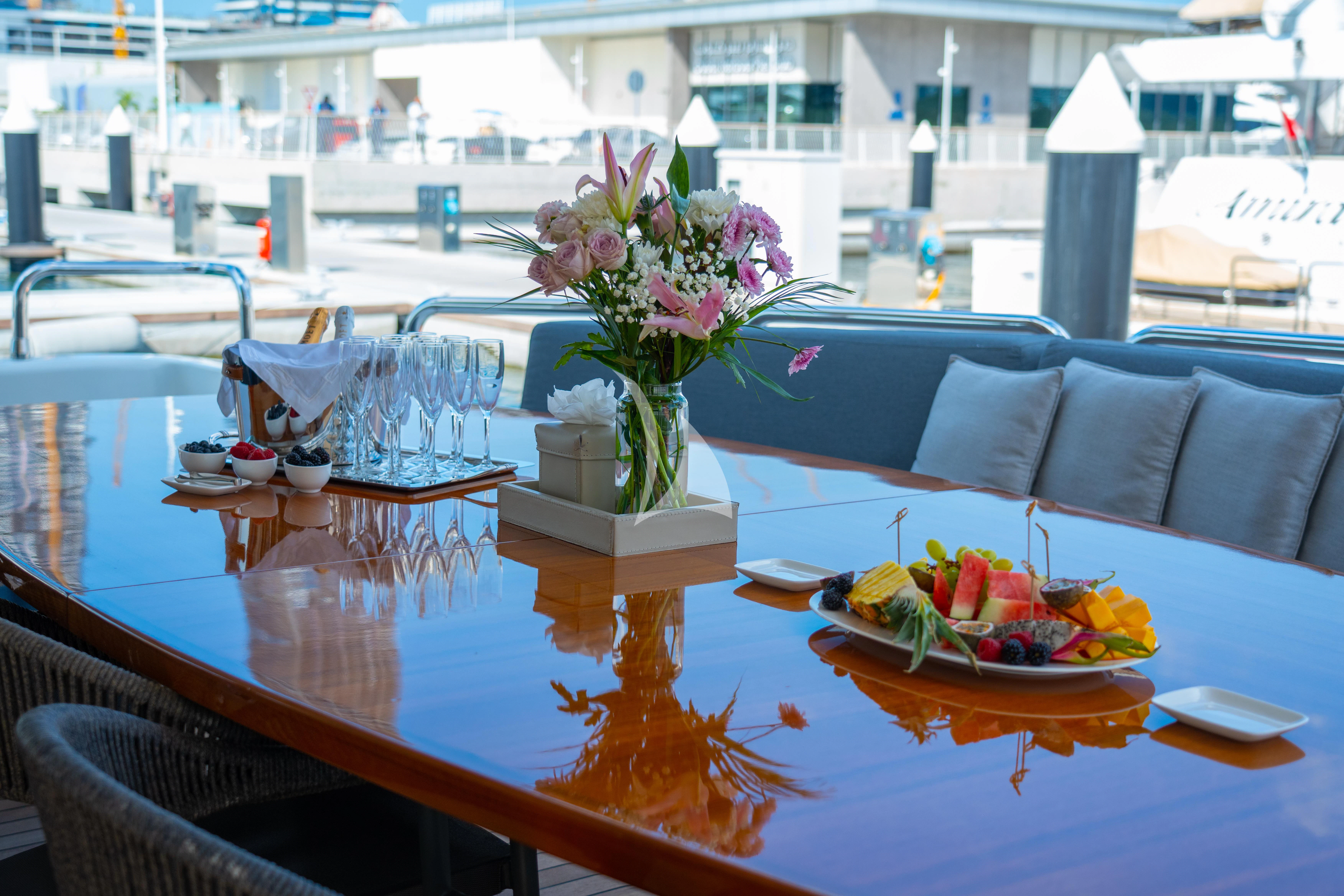 a table with a vase of flowers aboard HALLO Yacht for Sale