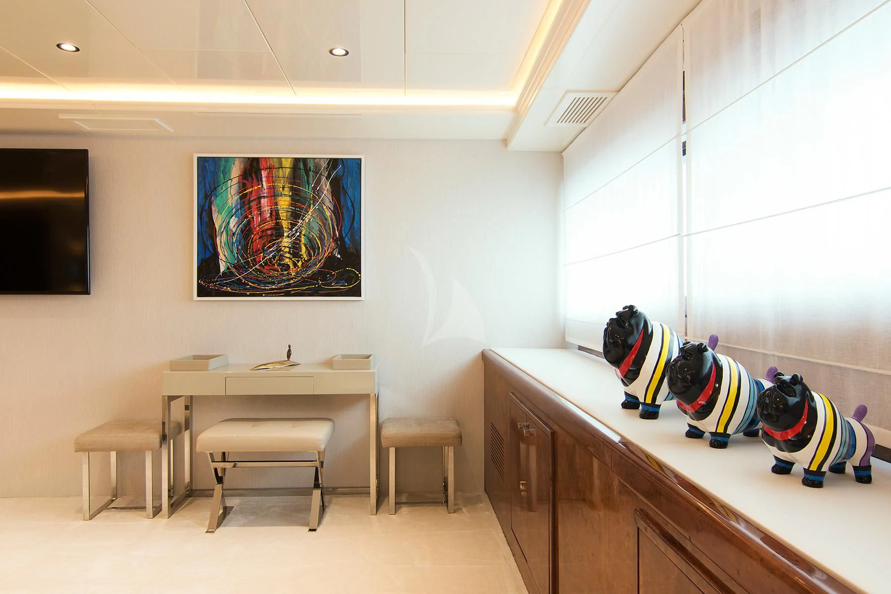 a room with a desk and a painting on the wall aboard HALLO Yacht for Sale