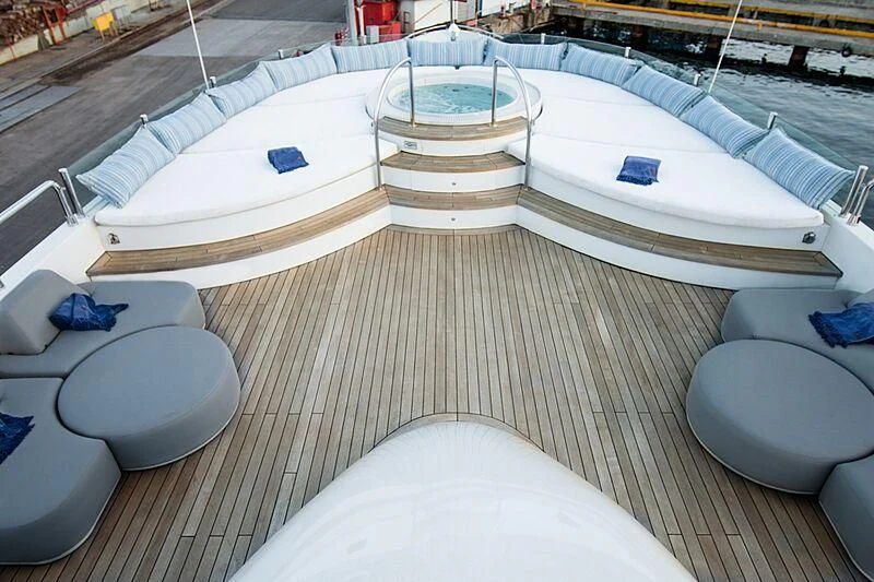a row of white lounge chairs aboard HALLO Yacht for Sale