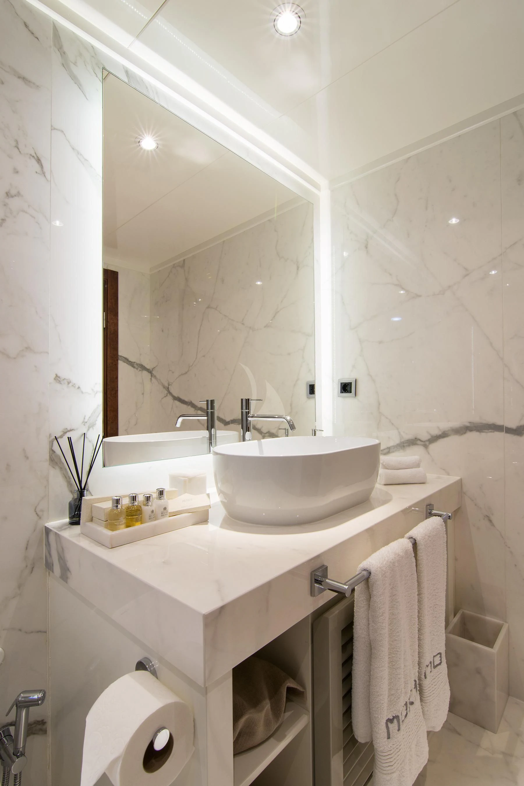 a bathroom with a sink and mirror aboard HALLO Yacht for Sale