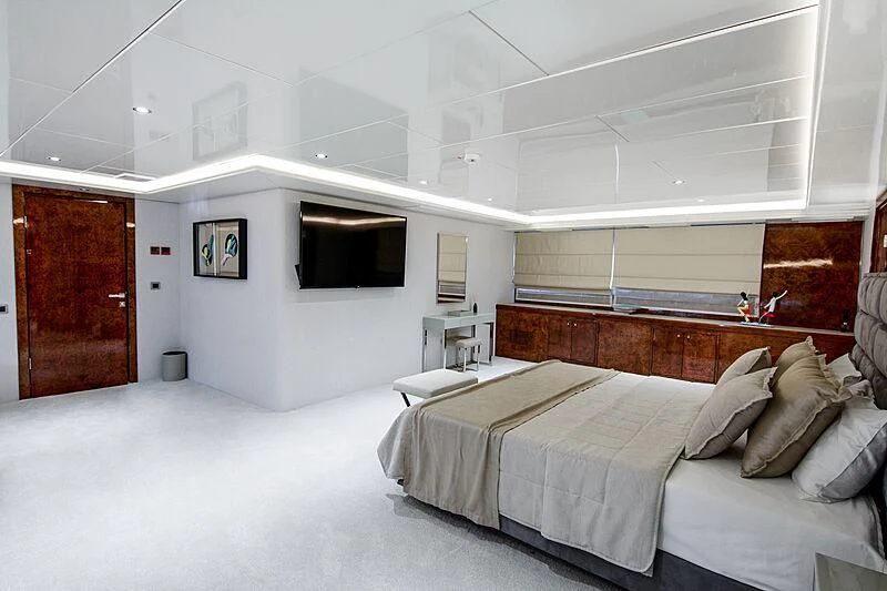 a room with a bed and a television aboard HALLO Yacht for Sale