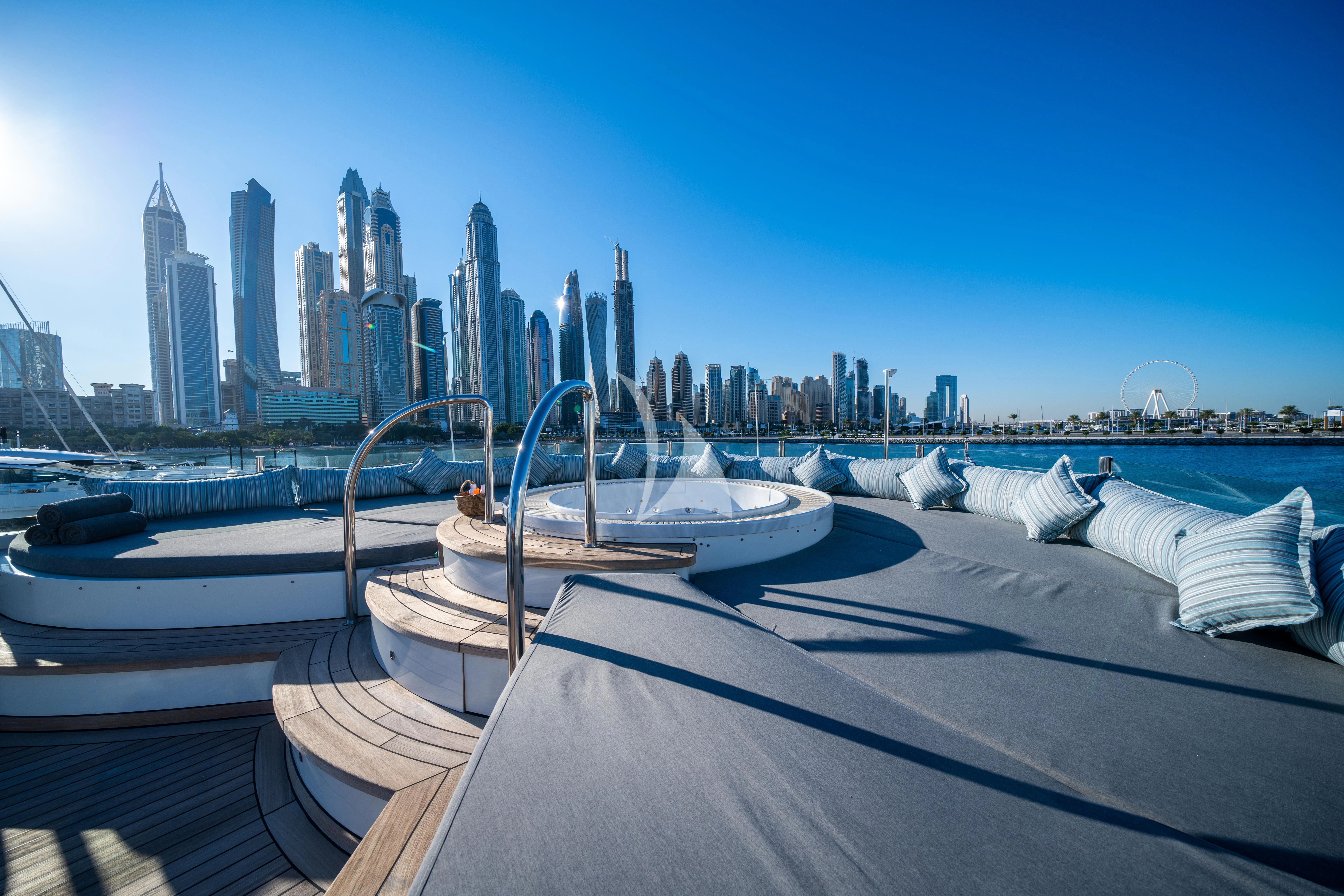 a boat docked in front of a city skyline aboard HALLO Yacht for Sale