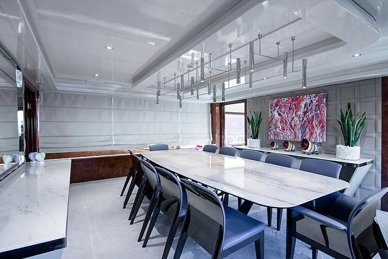 a room with a table and chairs aboard HALLO Yacht for Sale