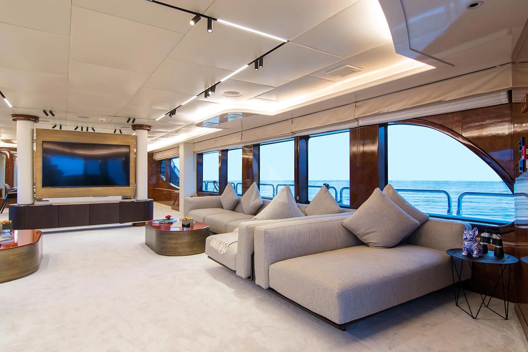 a living room with a large screen aboard HALLO Yacht for Sale