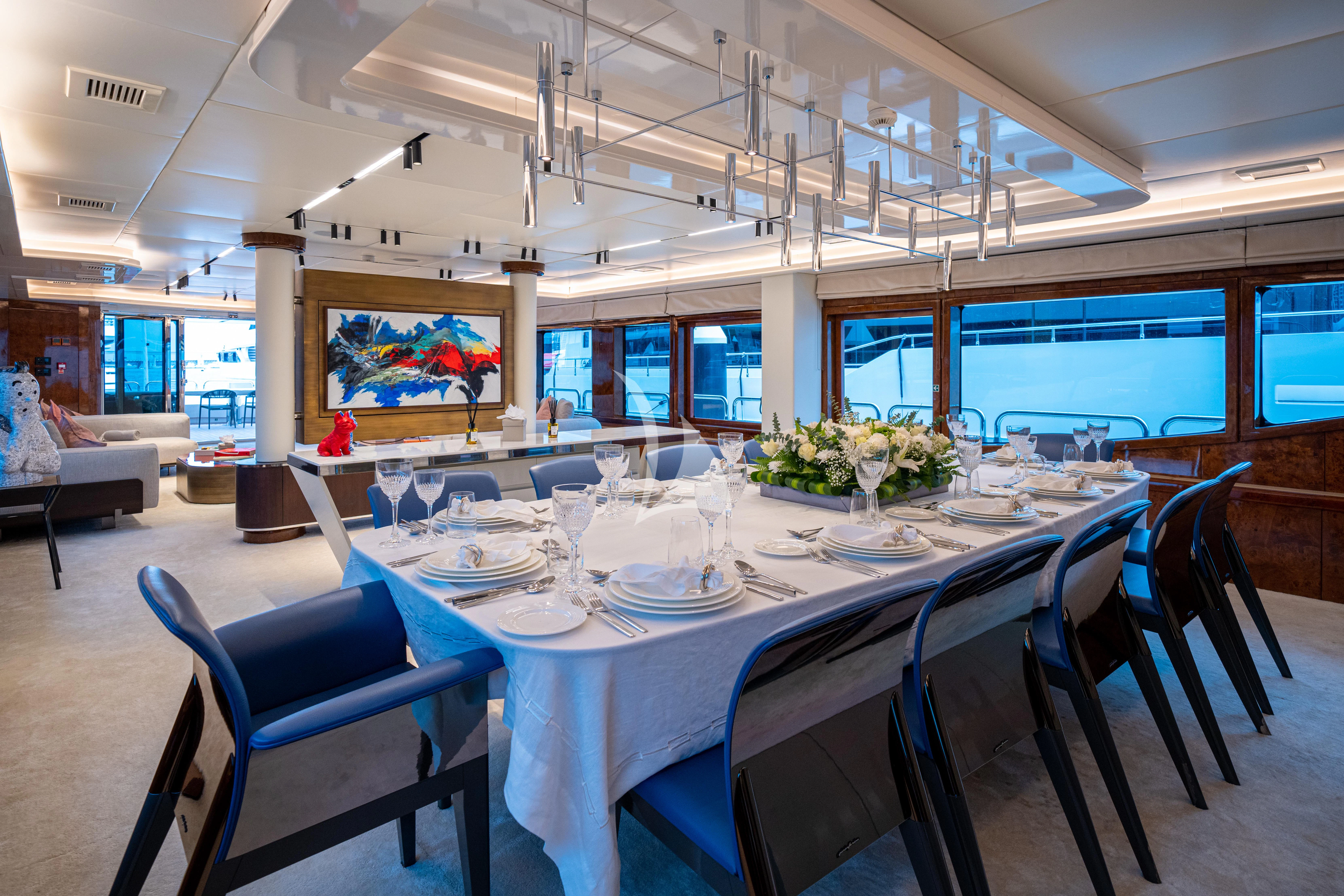 a large room with tables and chairs aboard HALLO Yacht for Sale