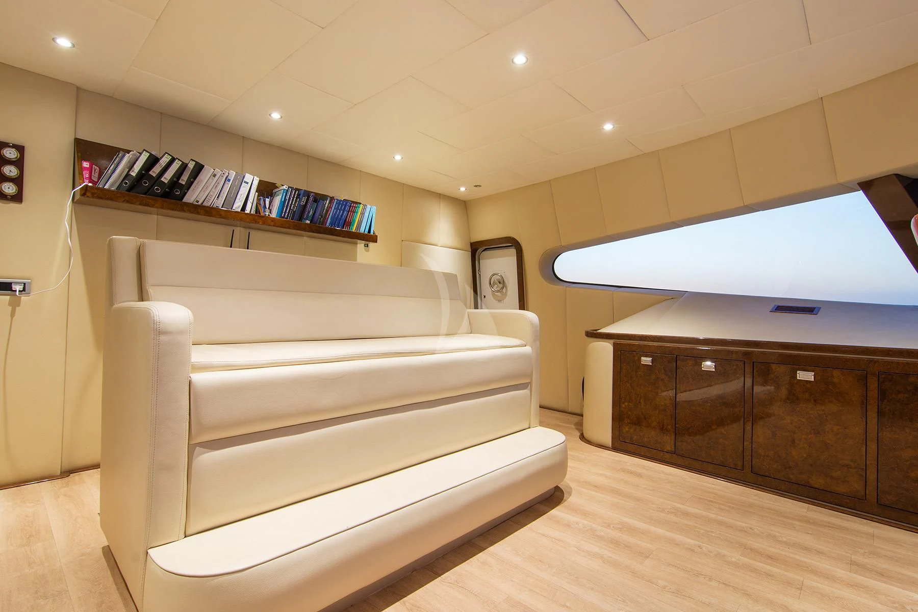 a room with a couch and a tv on the wall aboard HALLO Yacht for Sale