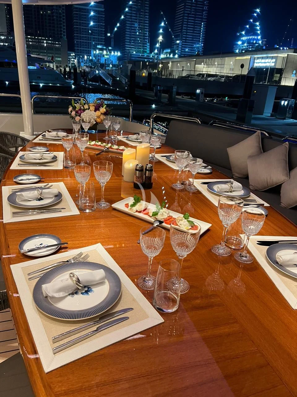 a table with plates and glasses aboard HALLO Yacht for Sale