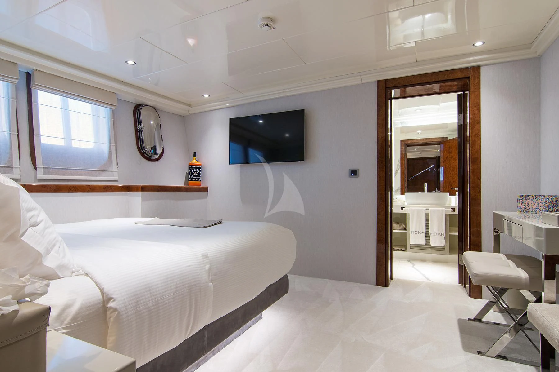 a room with a bed and a television on the wall aboard HALLO Yacht for Sale