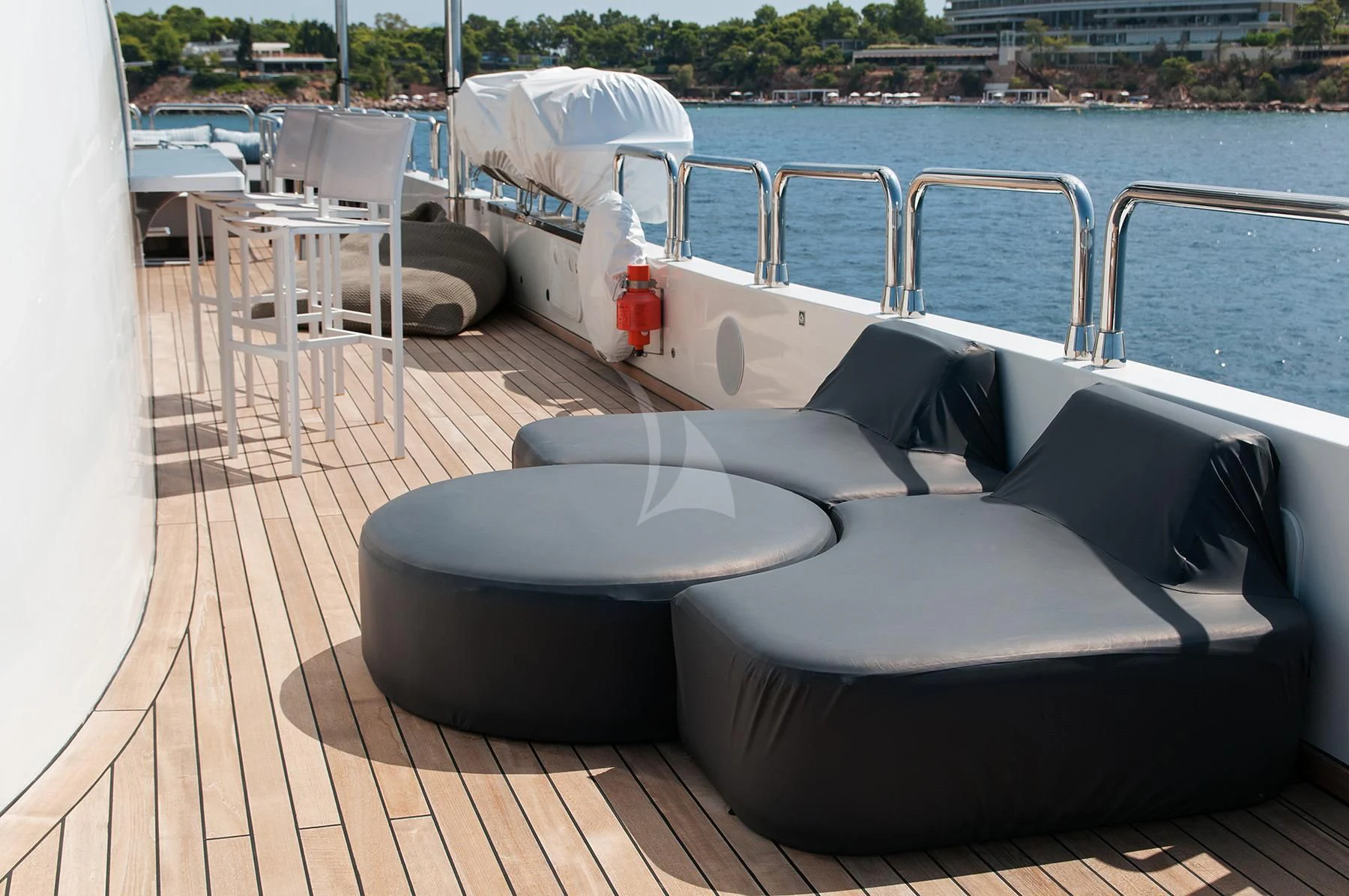 a deck with a couch and chairs on it aboard HALLO Yacht for Sale