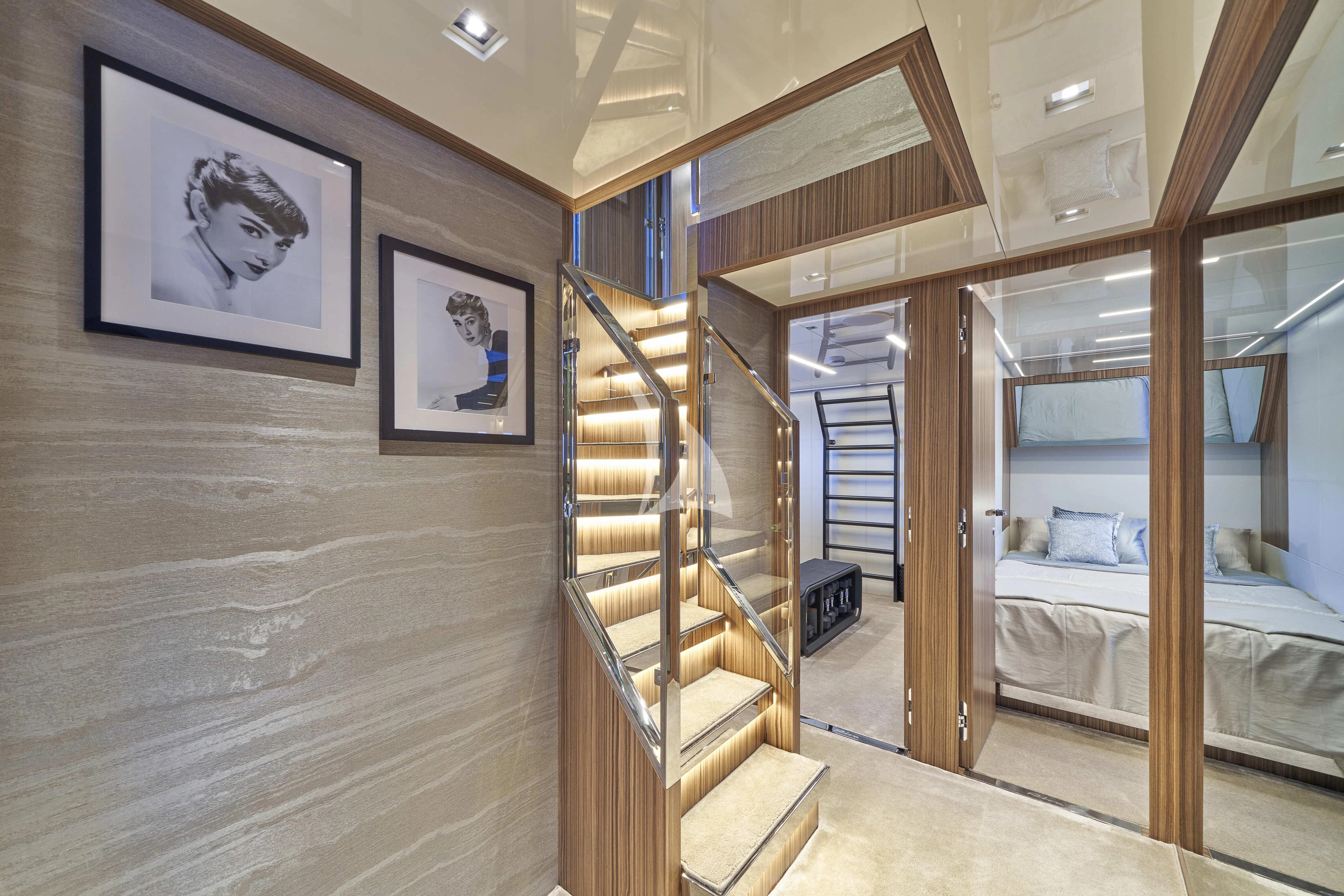 a room with a bed and a mirror aboard NIKITA Yacht for Sale