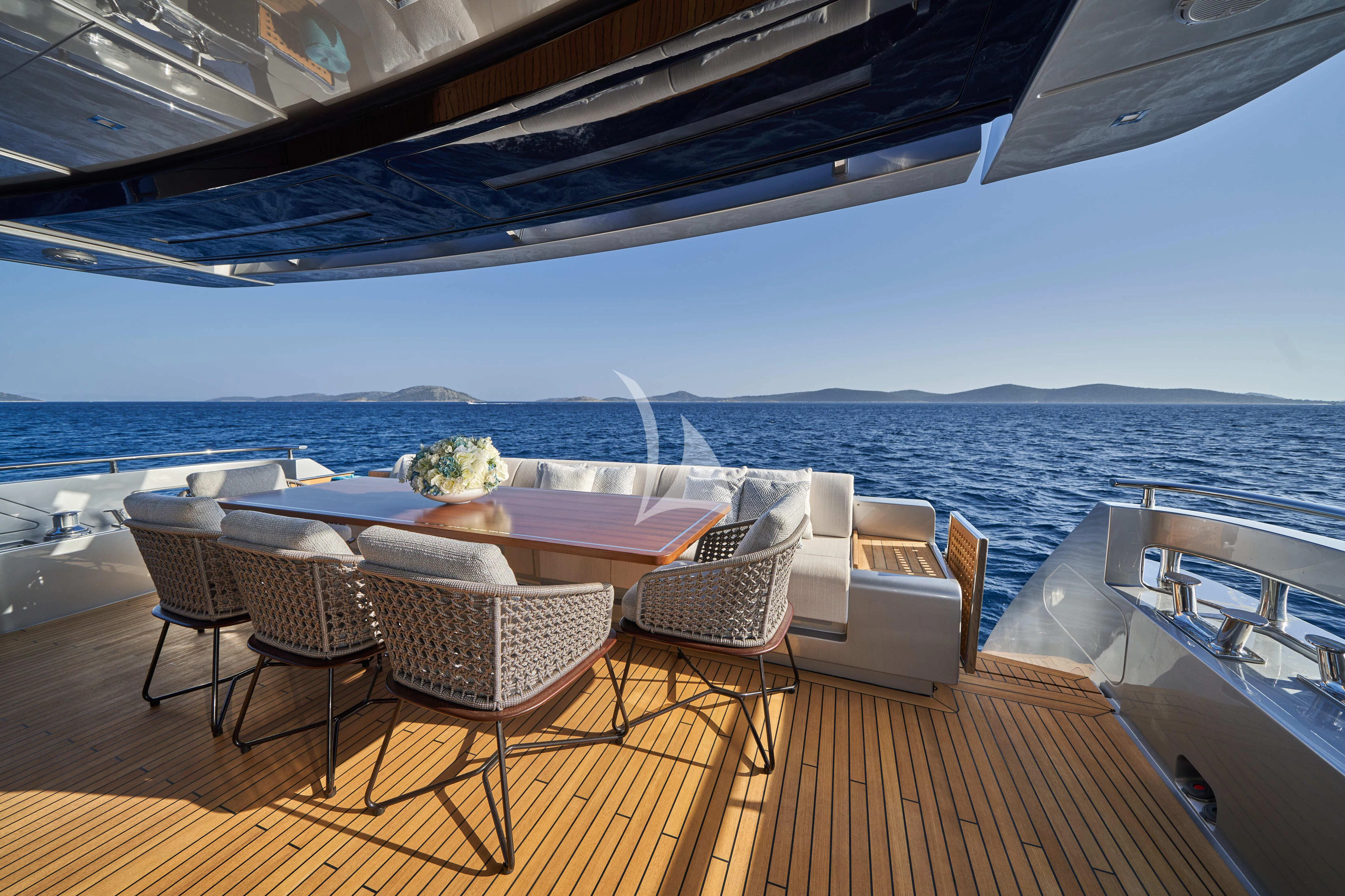 a deck with chairs and tables on it aboard NIKITA Yacht for Sale