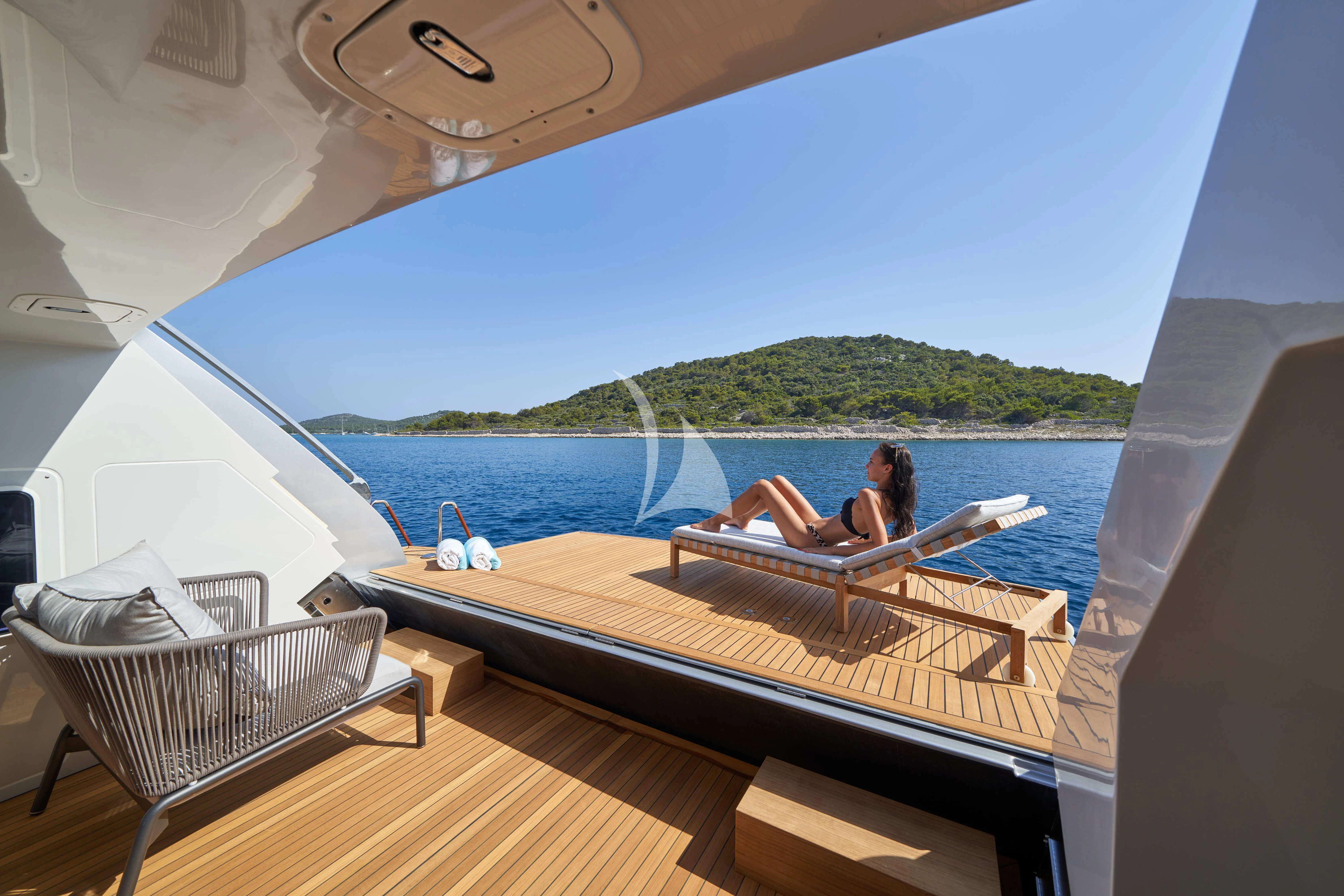 a person sitting on a lounge chair on a boat aboard NIKITA Yacht for Sale