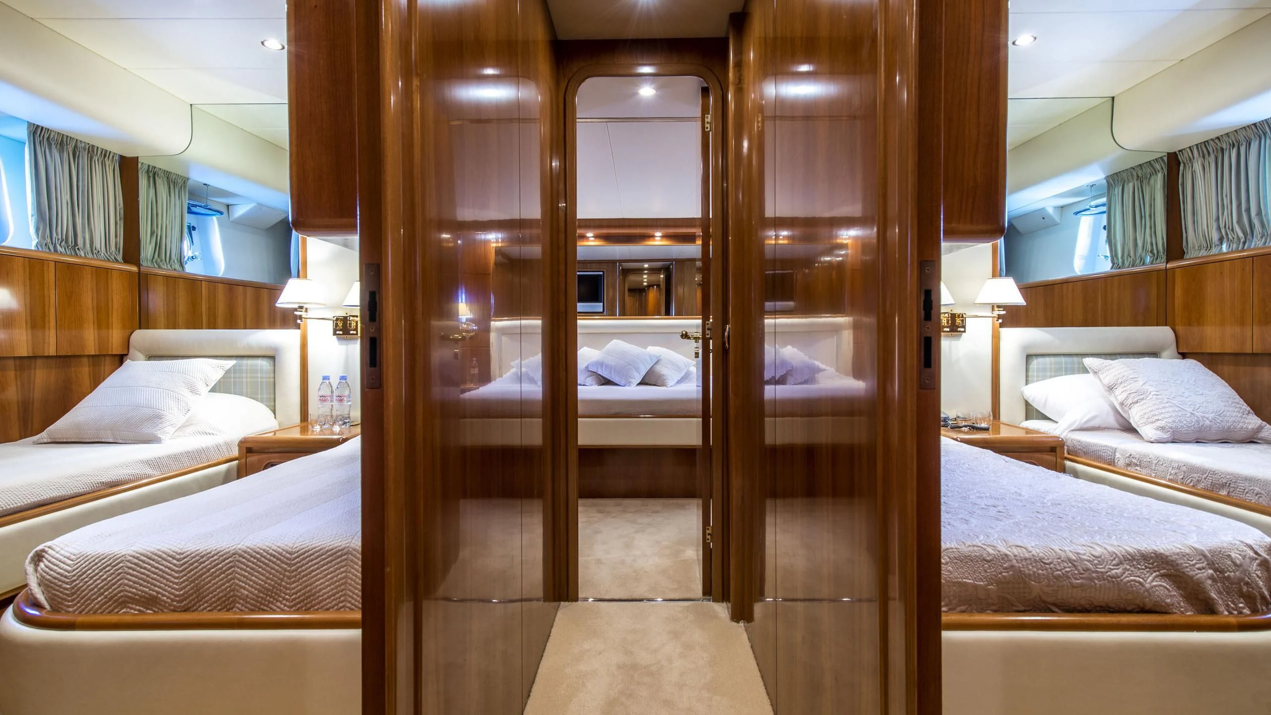 a room with a bed and a mirror aboard ACE1 Yacht for Sale