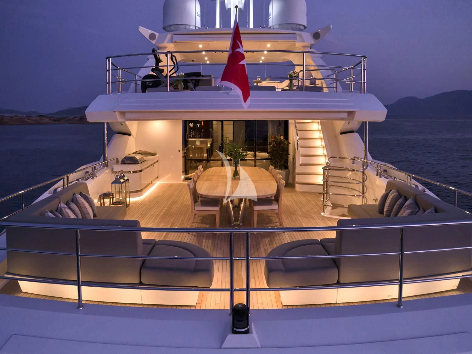 a deck with a table and chairs on it aboard AQUA LIBRA Yacht for Charter