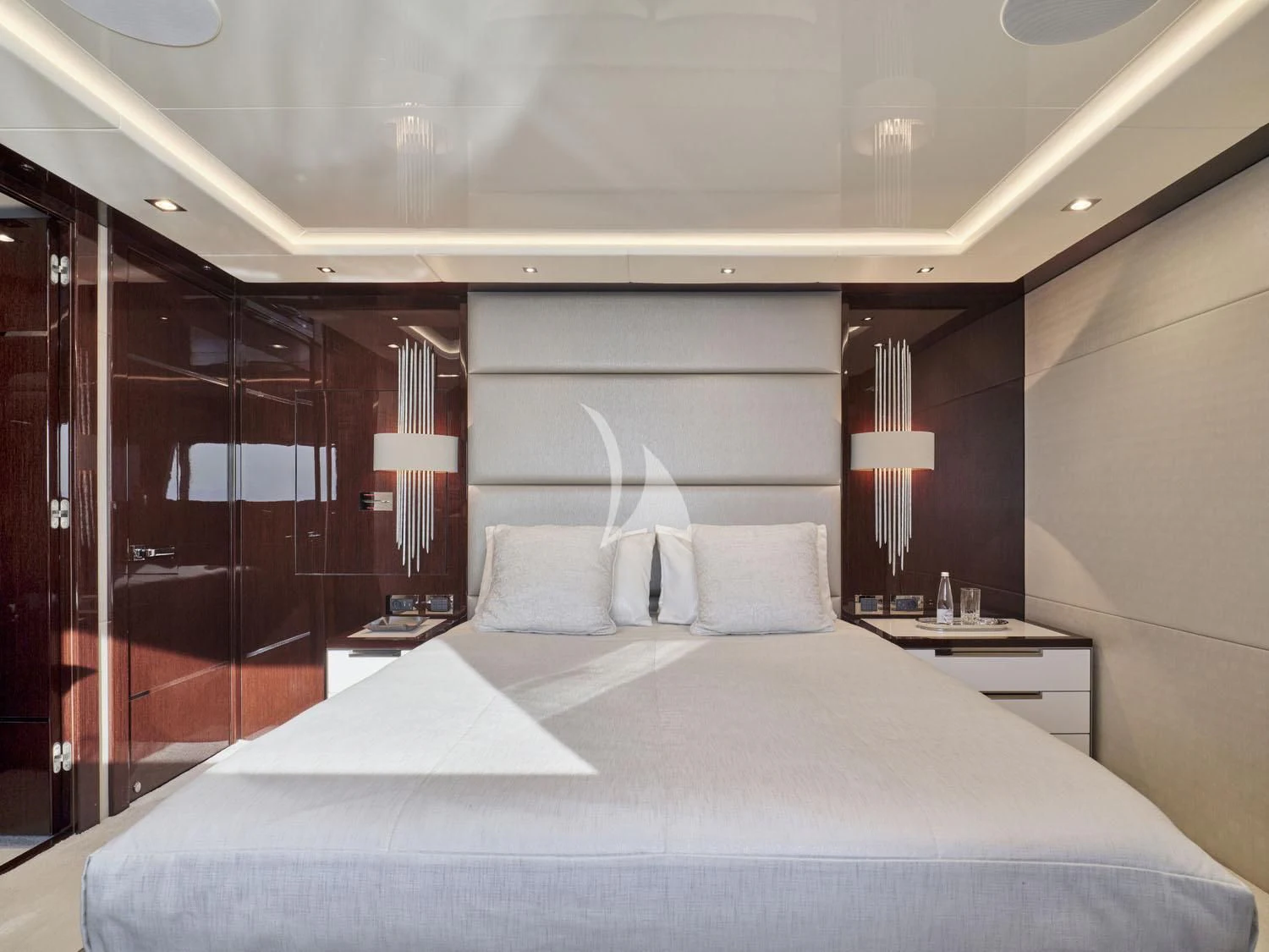 a bed with a white comforter aboard AQUA LIBRA Yacht for Charter