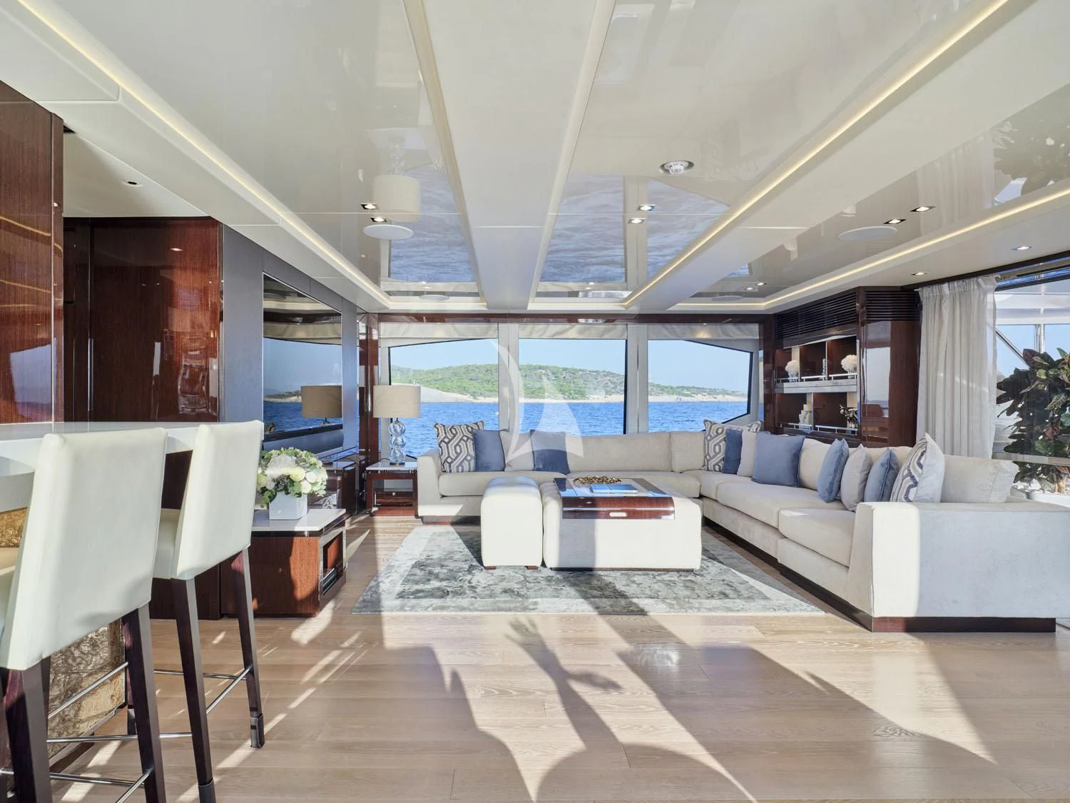 a living room with a large window aboard AQUA LIBRA Yacht for Charter
